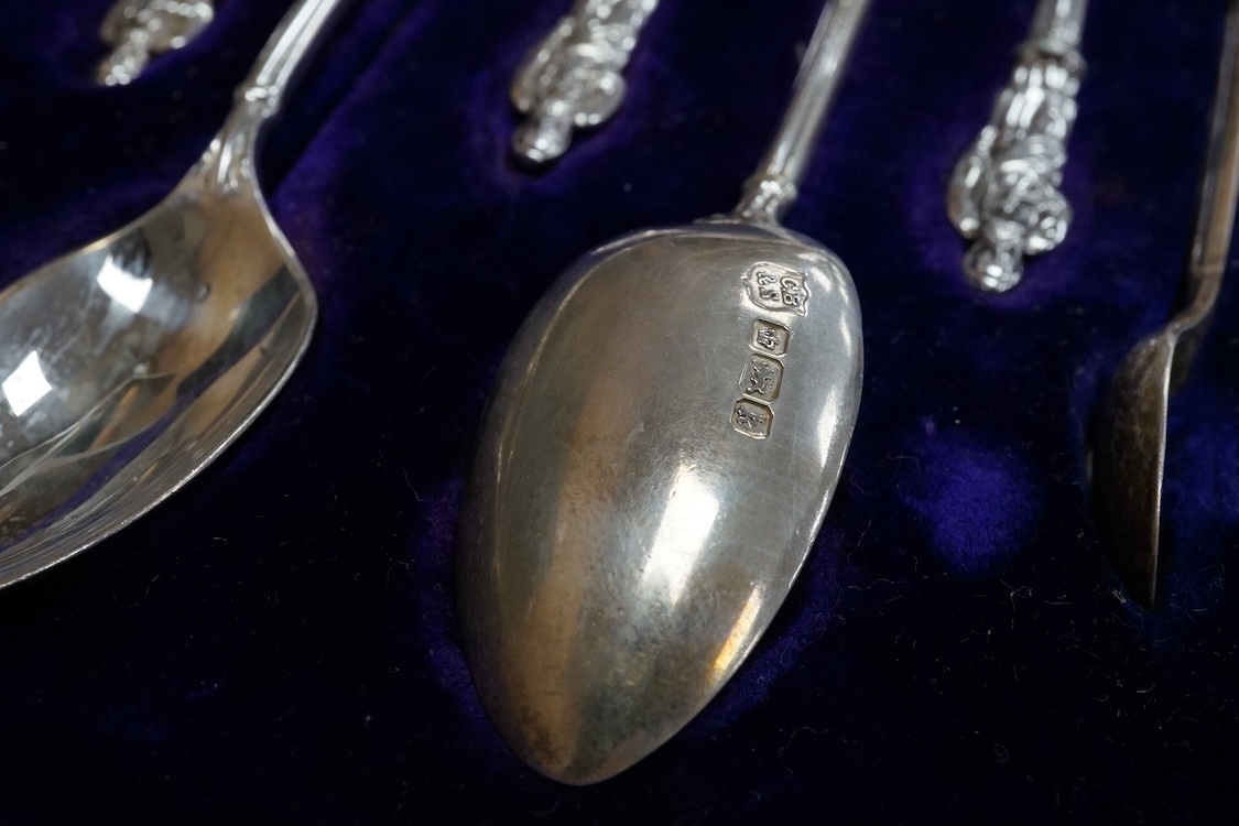 A cased set of twelve Edwardian silver apostle teaspoons with a pair of sugar tongs, Cooper Brothers & Sons, Sheffield, together with a cased Victorian silver bread knife and a cased set of six silver handled steel tea k
